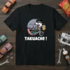 Black t-shirt with "TAQUACHE !" text and cartoon opossum riding a bicycle, wearing sunglasses and holding a drink