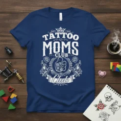 Tattoo Moms Club graphic tee featuring stylized text, roses, and tattoo machines. Includes central image of a mother holding a