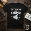 Black t-shirt with white text "TATTOOS ARE STUPID" and a graphic of a brain wearing a wizard hat