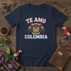 Navy blue t-shirt with "Te Amo Colombia" text, national coat of arms, and two macaws