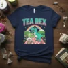 The "TEA REX" text is prominently displayed above a cute cartoon dinosaur enjoying tea, with a rainbow and nature scene
