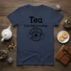 T-shirt with black text "Tea (n.): a hug in a mug" and a simple line drawing of hands holding a