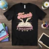 Retro Teach E DUCATIOION t-shirt design featuring an open book with rockets and musical notes