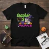 Teacher Trippin Halloween t-shirt design with ghost, books, witch hat, pumpkins, and E=MC(WITCH)² graphic