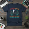 Teachers Can Do Virtually Anything Virtually Anything quote on a navy t-shirt with a bridge graphic and graduation cap icon