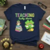 TEACHING lucky charm t-shirt design featuring an owl on books and a clover with a rainbow