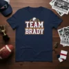 Navy blue t-shirt with "TEAM BRADY" text in white and red, featuring a football helmet graphic above