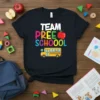 Team Preschool text with apple and school bus graphic on a black t-shirt, perfect for back to school