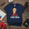 Team Sarah t-shirt with cartoon blonde woman wearing glasses and plaid shirt, featuring text "TEAM SARAH"