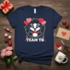 Team TK t-shirt design with a cute badger holding heart balloons within a green leafy wreath, white text below