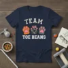 Team Toe Beans t-shirt design with three colorful paw prints and bold white text
