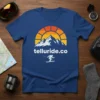 Telluride.co ski mountain sunset t-shirt design featuring a skier silhouette, mountains, and a colorful sun arc