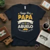 Spanish t-shirt design saying "Tengo Dos Papá y Abuelo y Me Encantan Los Dos" with bold typography and a mustache