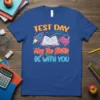 Test Day May The Skills BE WITH YOU t-shirt design featuring a rocket, open book, and brain graphic