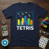 Navy blue t-shirt featuring the Tetris logo with colorful pixelated falling blocks and cityscape graphic