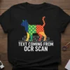 Black t-shirt with a colorful patchwork cat design above the text "TEXT COMING FROM OCR SCAN"