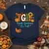 T-shirt with "T G I F Thank Goodness It's Fall" text and autumn graphics like pumpkins, a sunflower, and a