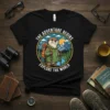 The Adventure Begins Explore The World t-shirt with a cute otter hiker graphic in a mountain landscape