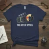 The Art of Optics t-shirt design featuring camera lens elements and aperture blades with white text