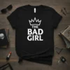 The Bad Girl T-Shirt with a white crown graphic and bold text, perfect for sassy women