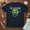 The Bahamas text with a retro sunset, palm trees, and island graphic on a navy t-shirt