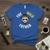 The Bald Father t-shirt design featuring stylized text and a cartoon head with a hat and beard