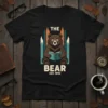 The Bear Est. 1892 t-shirt design featuring a brown bear wearing glasses reading a book, with stylized mountains in the