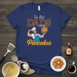 The Best DADS Make Pancakes t-shirt design featuring a muscular chef holding a stack of pancakes