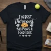 Black t-shirt with white text "The Best Therapist Has Paws & Four Legs" and a golden retriever graphic