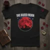 The Blood Moon t-shirt design featuring a red moon with bats and mountains, text at the top
