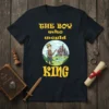 The Boy Who Would King t-shirt design with a young prince holding a sword before a castle