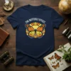 The Butterfly Effect T-Shirt featuring a monarch butterfly graphic with sun rays and white text