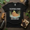 Black t-shirt featuring "The Capybara & Friends River Sanctuary" text with a capybara and frog illustration in water
