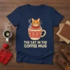 The Cat In The Coffee Mug t-shirt design featuring an orange tabby cat wearing a sweater inside a festive coffee