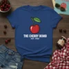 The Cherry Bomb Est. 1990 T-Shirt with a red cartoon cherry graphic and white text