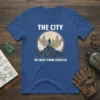 The City We Built From Scratch quote on a blue t-shirt with a graphic of a person standing on a