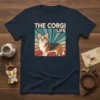 Retro t-shirt design featuring the text "THE CORGI LIFE" above a stylized corgi dog with a vintage sunburst background