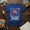 The Cosmic Journey Awaits Beyond text on a blue t-shirt with a colorful atom and silhouette of a person standing