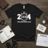 Black t-shirt with white text '2-8-24 THE COUNTDOWN IS ON' and stopwatch graphic, indicating a countdown