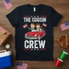 The Cousin Crew text with cartoon of three cousins in a red convertible, holding American flags, on a navy t-shirt