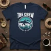 The Crew t-shirt design featuring a shark in waves, with "The Crew" text above