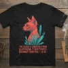 Black t-shirt with a geometric red cat illustration surrounded by teal crystals, featuring the text "THE DESIGN A COMPLTELly NEW