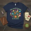 The earth laughs in flowers quote with colorful floral wreath graphic on a navy t-shirt