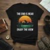 Black t-shirt with "THE END IS NEAR ENJOY THE VIEW" text over a vibrant mountain sunset landscape graphic