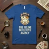 The Feline Detective Agency text on a blue t-shirt featuring a cartoon cat detective in a hat and trench coat