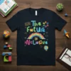 The future is inclusive text with rainbow and diverse figures graphic on a navy t-shirt, ideal for educators