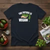 Navy t-shirt with white text "THE FUTURE IS VEGAN!" and a graphic of a hand holding fresh greens