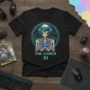 The Gamer XI t-shirt with a skeleton wearing VR goggles and holding a controller, set against a circuit board background
