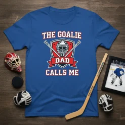 The Goalie Dad Calls Me t-shirt design with hockey goalie mask, crossed sticks, and shield graphic