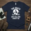 The Goats Are Calling I Must Go text with white goat graphics on a navy t-shirt, designed for outdoor enthusiasts
